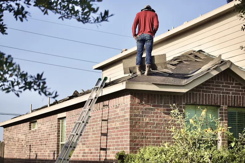 Professional roofer working on a residential roof in Northeast Park